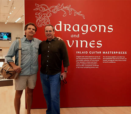 Bill Seymour with friend in front Dragons & Vines exhibit wall