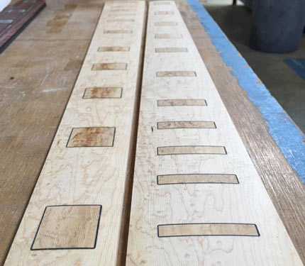 Detail of two Elrick fretboards with Pearl Works inlay